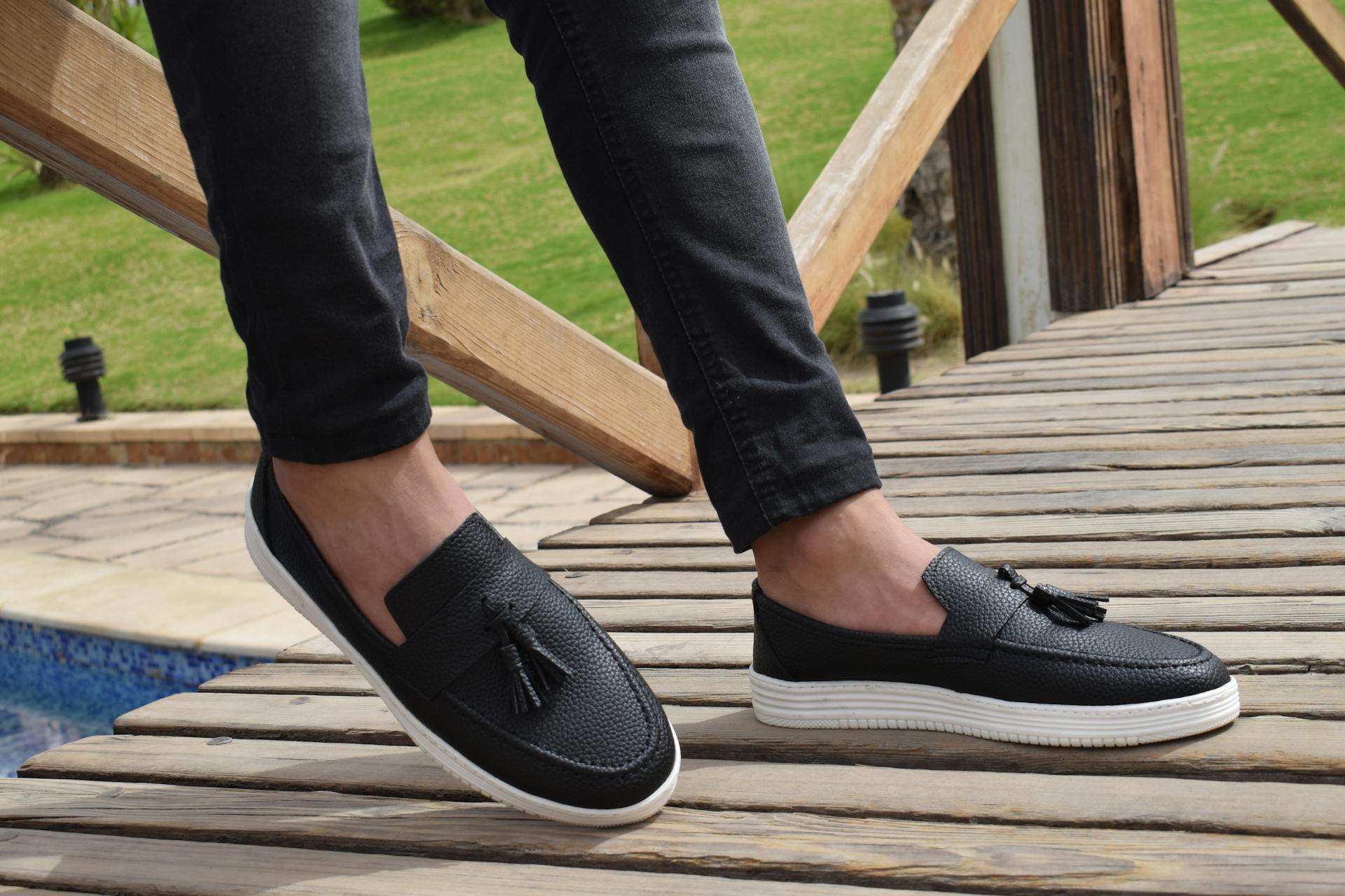 black loafers orbiana on model stepping on wood
