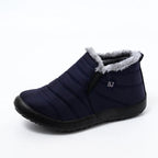 Navy blue slip-on winter ankle boots with fur trim and quilted design for cold weather protection