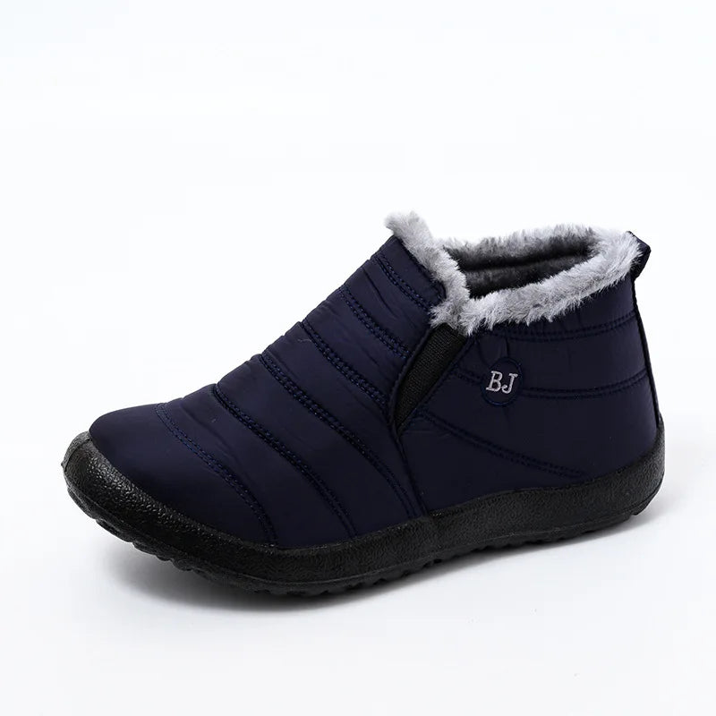 Navy blue slip-on winter ankle boots with fur trim and quilted design for cold weather protection