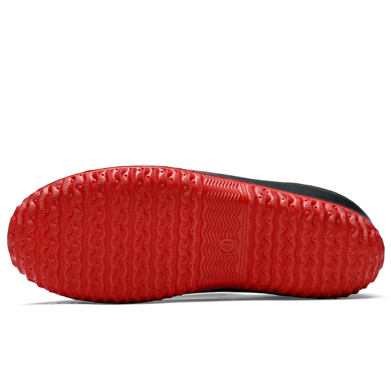  Close-up of textured red rubber non-slip sole on waterproof work shoes showing grip pattern