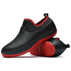 Waterproof slip-on work shoes in black with red non-slip sole for kitchen professionals